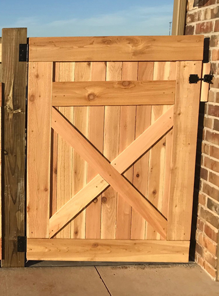 Cedar gate with rustic X design.