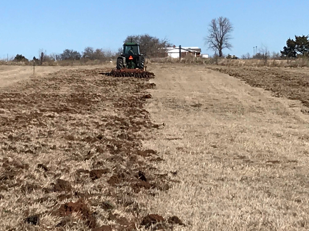 Using a disc plow to prepare the soil for planting wildflowers